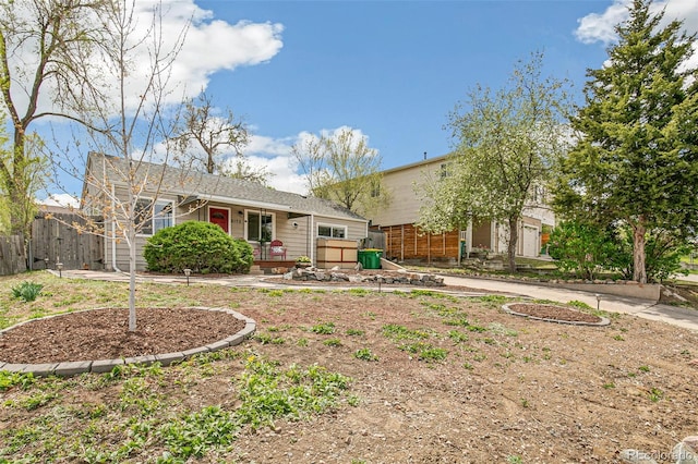 back of property featuring fence and a garage