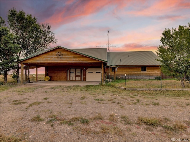 view of front facade featuring a garage and a carport