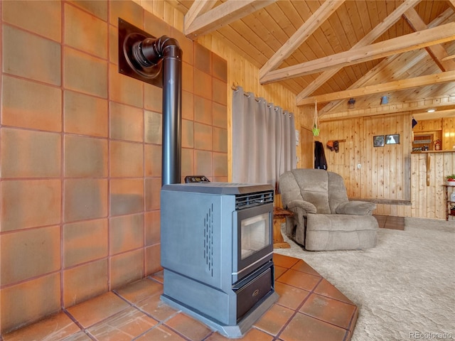 living room featuring a wood stove, wood walls, carpet floors, and wood ceiling