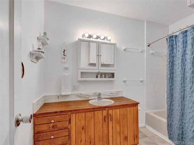 bathroom featuring tile patterned flooring, shower / bath combo, a textured ceiling, and vanity