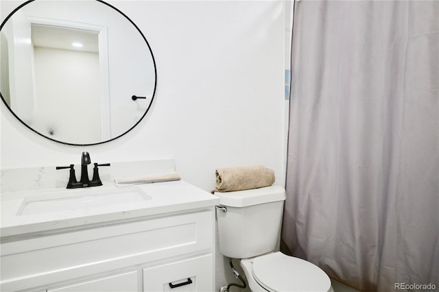 bathroom featuring vanity and toilet