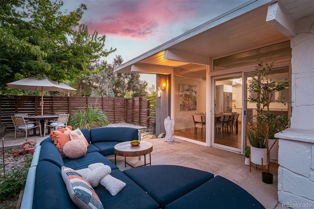 patio terrace at dusk featuring outdoor lounge area