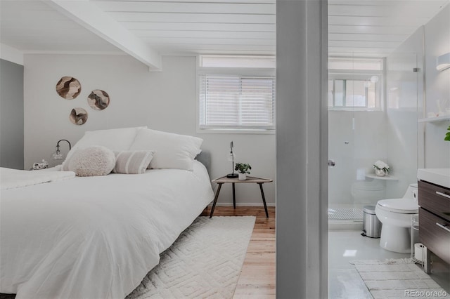 bedroom with wooden ceiling, beamed ceiling, multiple windows, and light hardwood / wood-style flooring