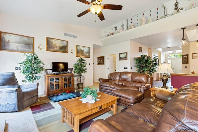 living room featuring ceiling fan and high vaulted ceiling