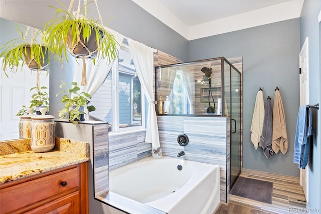 bathroom featuring wood-type flooring, vanity, and independent shower and bath