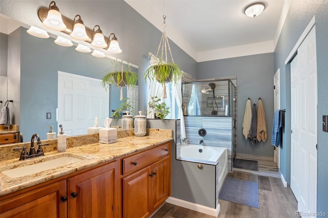 bathroom with independent shower and bath, vanity, and hardwood / wood-style flooring