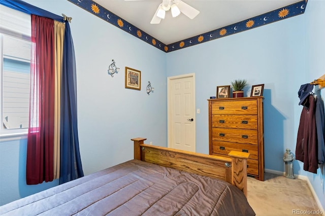 carpeted bedroom with multiple windows and ceiling fan