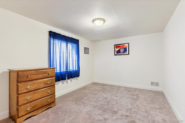 carpeted bedroom with a textured ceiling