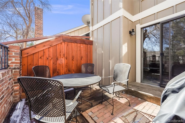 wooden deck with outdoor dining area and a patio area