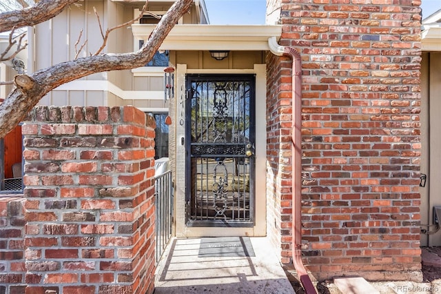 view of exterior entry with brick siding