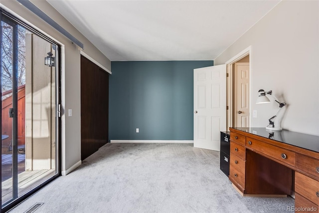 interior space with baseboards, carpet floors, visible vents, and access to outside