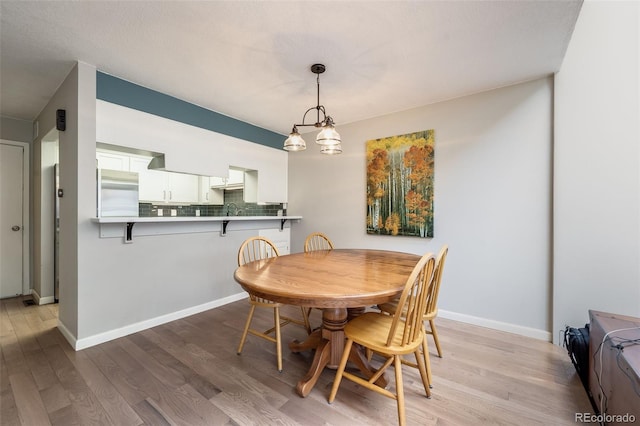 dining room featuring baseboards and wood finished floors