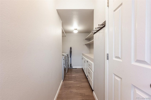 laundry room featuring dark wood-style flooring, laundry area, baseboards, and separate washer and dryer