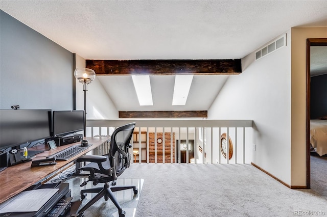 home office featuring carpet, baseboards, visible vents, a textured ceiling, and lofted ceiling with skylight