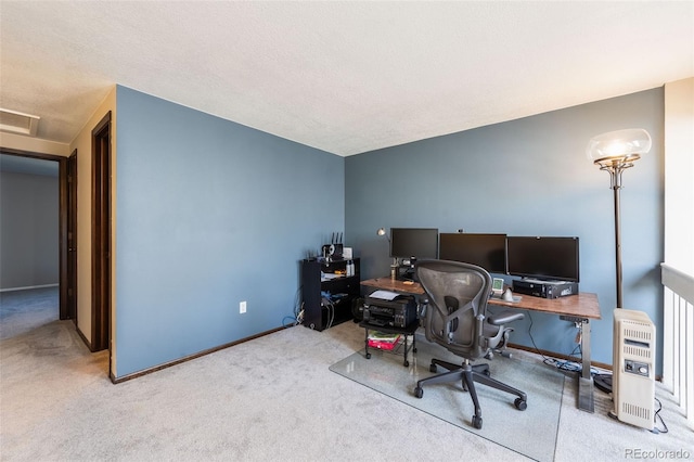 carpeted office space with visible vents, baseboards, a textured ceiling, and attic access