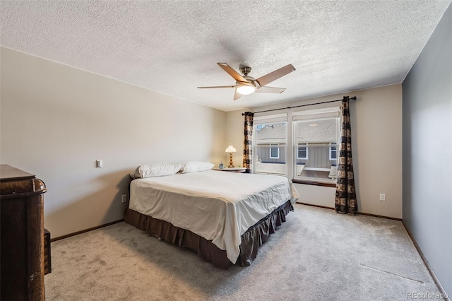 bedroom with light colored carpet, baseboards, and ceiling fan