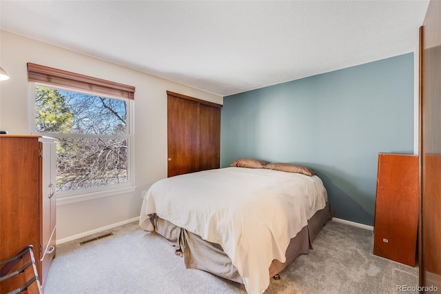 bedroom featuring carpet flooring, baseboards, and visible vents