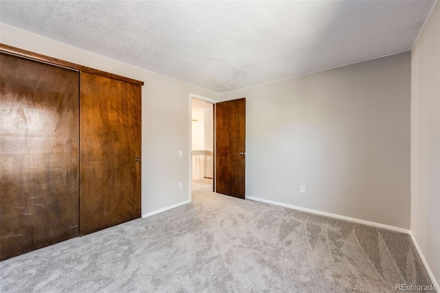 11710 Elk Head Range Rd, Littleton, CO 80127 - unfurnished bedroom with carpet floors, a closet, and a textured ceiling