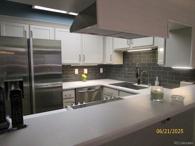 11710 Elk Head Range Rd, Littleton, CO 80127 - kitchen featuring appliances with stainless steel finishes, decorative backsplash, white cabinets, and light countertops