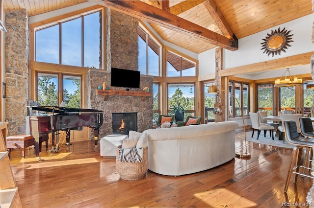 living room featuring a chandelier, high vaulted ceiling, beamed ceiling, and hardwood / wood-style flooring