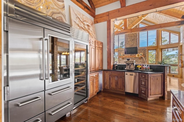 kitchen featuring stainless steel appliances, wooden ceiling, tasteful backsplash, and beam ceiling