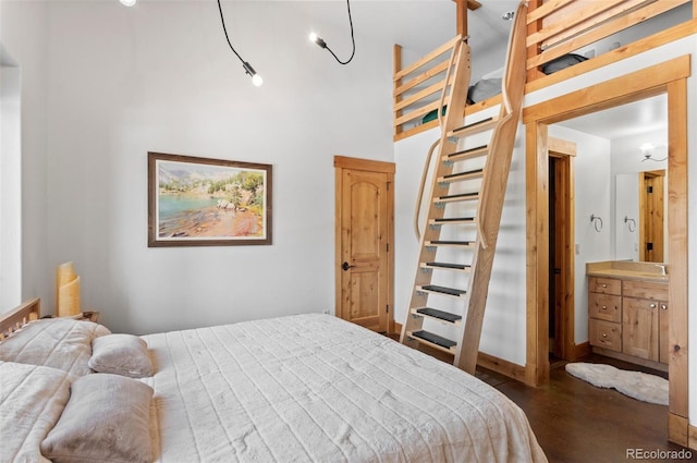 bedroom featuring a towering ceiling