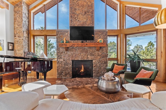 living room with a fireplace, wooden ceiling, and a healthy amount of sunlight