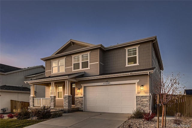 craftsman inspired home with a garage and a porch