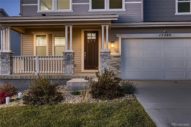 property entrance featuring a garage and covered porch