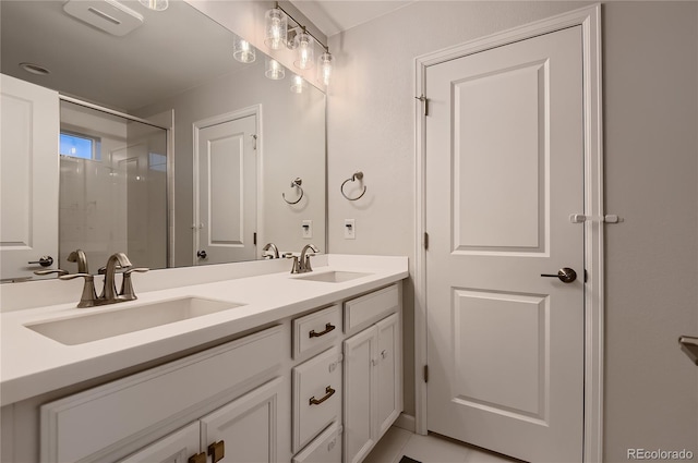 bathroom featuring a shower with door and vanity