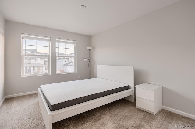 bedroom featuring light carpet