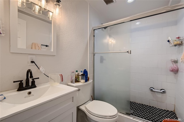 bathroom with vanity, toilet, and an enclosed shower