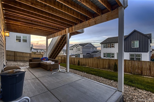 patio terrace at dusk featuring an outdoor hangout area