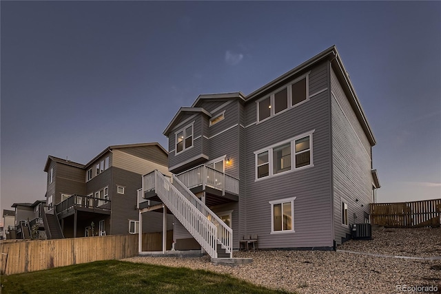 rear view of property featuring a yard and central AC unit