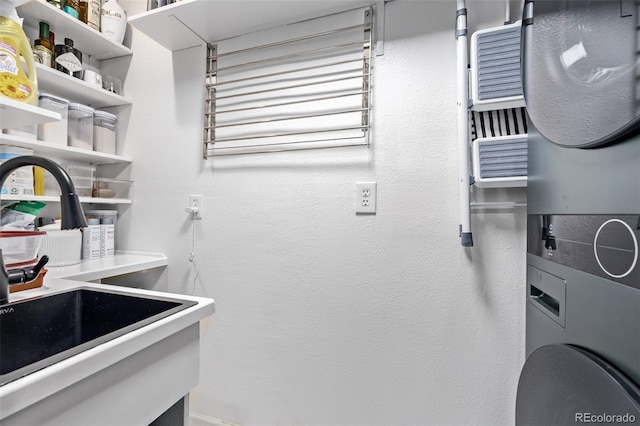 laundry room featuring a sink, laundry area, and stacked washer / dryer