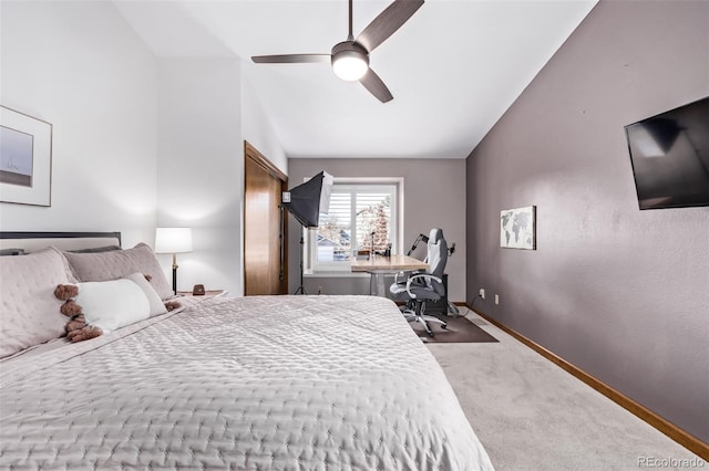 bedroom featuring baseboards, carpet flooring, a ceiling fan, and lofted ceiling