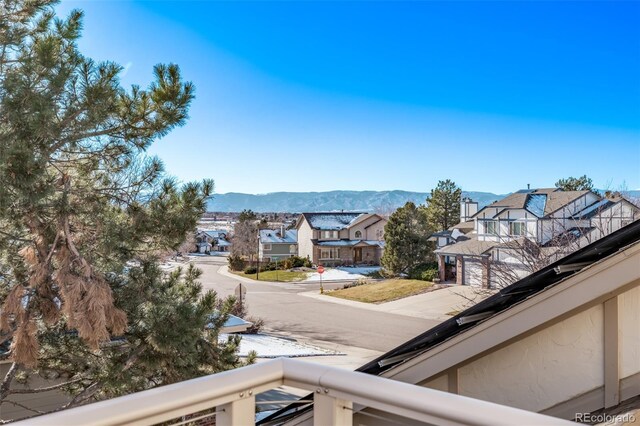 balcony featuring a residential view and a mountain view