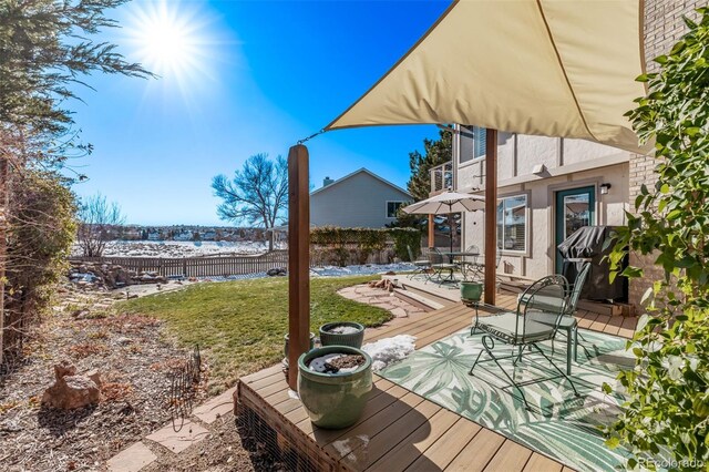 deck with a lawn, a patio, and fence