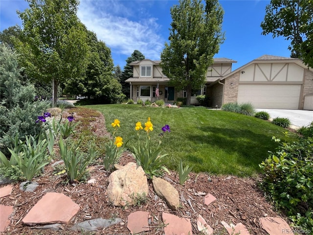 view of front of home featuring a garage, concrete driveway, and a front yard