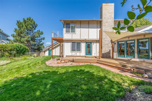 1324 Shadow Mountain Dr, Highlands Ranch, CO 80126 - back of property with a wooden deck, a chimney, and stucco siding