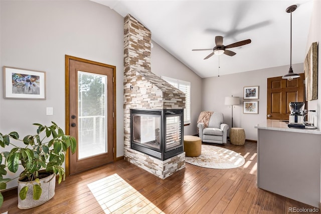 1324 Shadow Mountain Dr, Highlands Ranch, CO 80126 - living area with a multi sided fireplace, ceiling fan, hardwood / wood-style flooring, healthy amount of natural light, and high vaulted ceiling