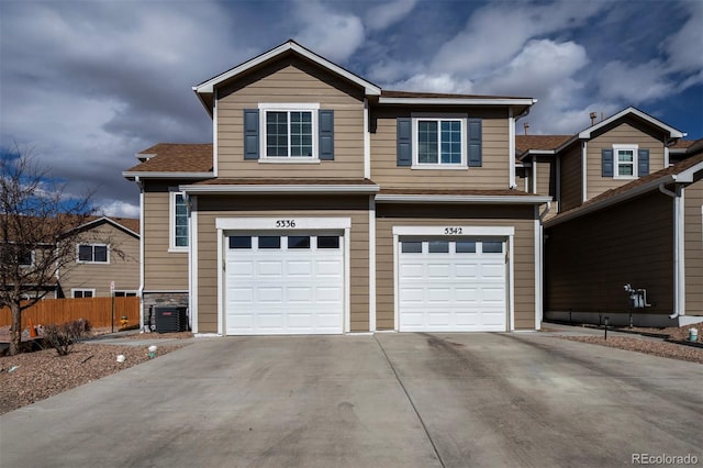 view of front of home featuring fence, driveway, and an attached garage