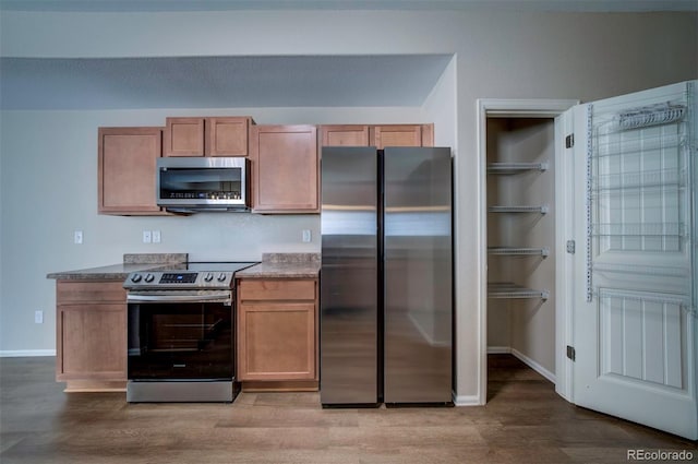 5336 Blair Vw, Colorado Springs, CO 80916 - kitchen featuring dark countertops, light wood-style floors, baseboards, and stainless steel appliances