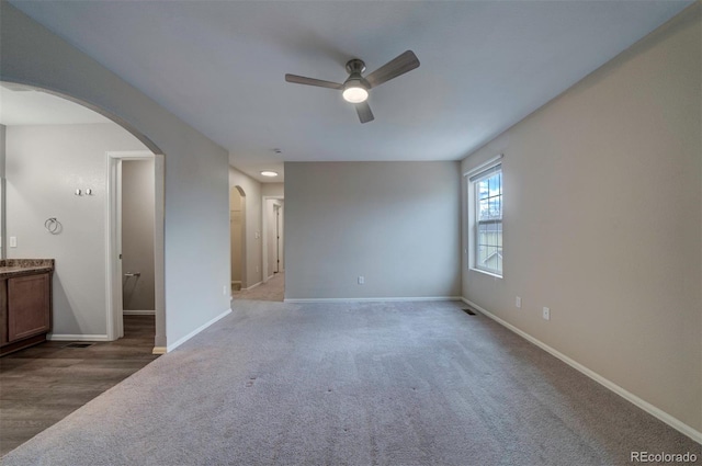 5336 Blair Vw, Colorado Springs, CO 80916 - unfurnished room with arched walkways, ceiling fan, visible vents, baseboards, and carpet