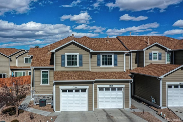 5336 Blair Vw, Colorado Springs, CO 80916 - view of front of property featuring a garage, driveway, a shingled roof, and cooling unit