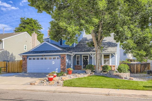 8985 W Quarto Pl, Littleton, CO 80128 - view of front of property with concrete driveway, brick siding, a porch, an attached garage, and roof with shingles