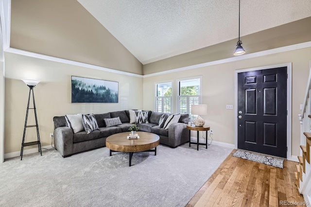 8985 W Quarto Pl, Littleton, CO 80128 - living room featuring a textured ceiling, wood finished floors, and high vaulted ceiling