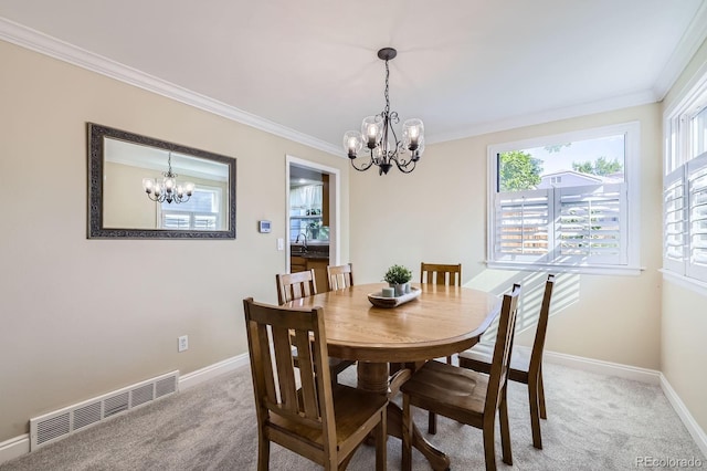 8985 W Quarto Pl, Littleton, CO 80128 - dining area featuring a chandelier, light carpet, and ornamental molding