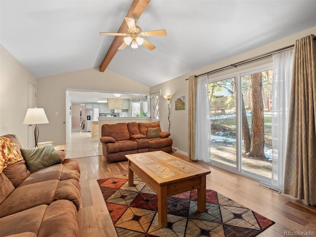 living room with ceiling fan, light hardwood / wood-style flooring, and lofted ceiling with beams