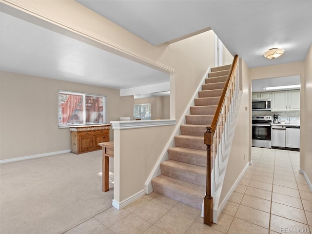 staircase featuring carpet flooring